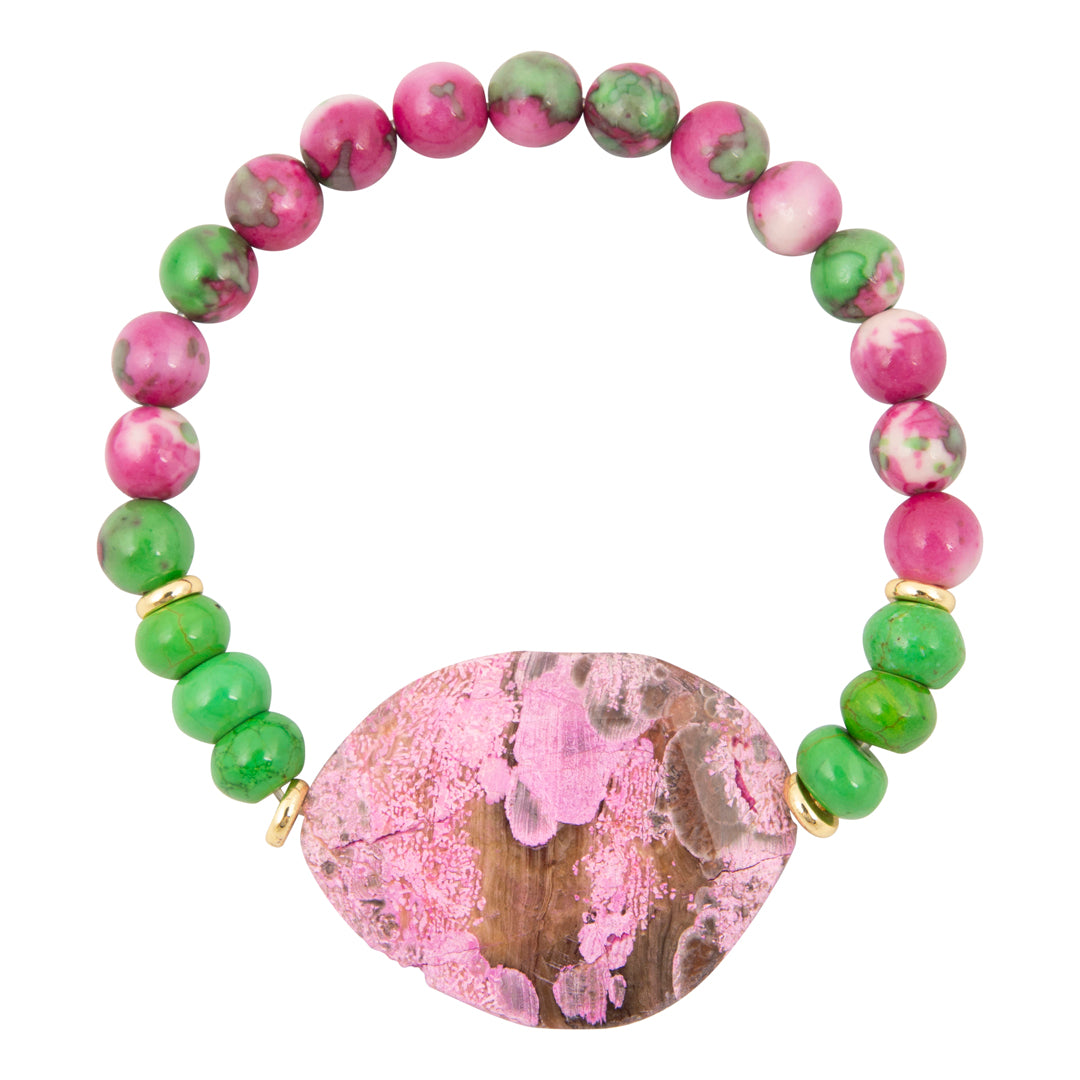 Bracelet with pink and green beads and a large pink stone on a white background