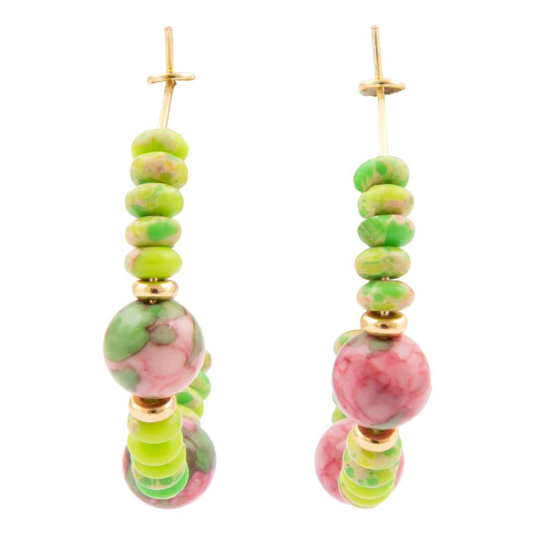 Pair of earrings with green and pink beaded design on a white background