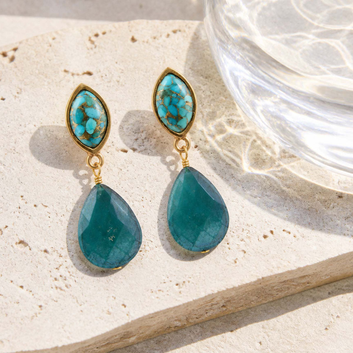 Barse Gilded Oasis turquoise and teal crystal earrings on a styled light background.