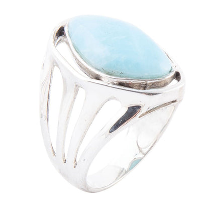 Silver ring with a large blue stone on a white background