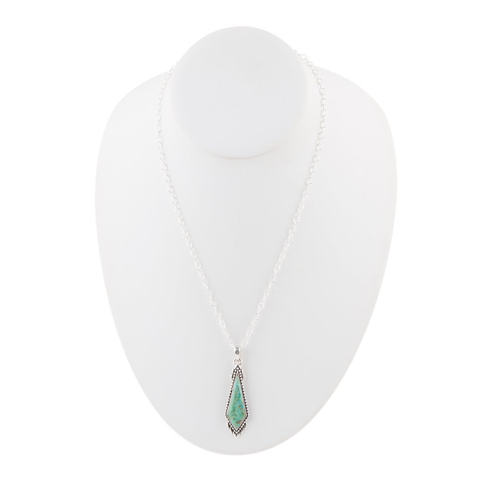 Necklace with a green pendant on a white background