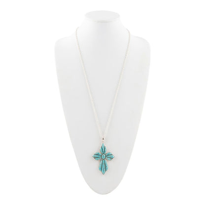 Turquoise cross pendant necklace on a white mannequin bust