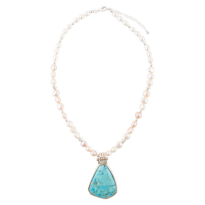 Necklace with turquoise pendant and pearl chain on a white background