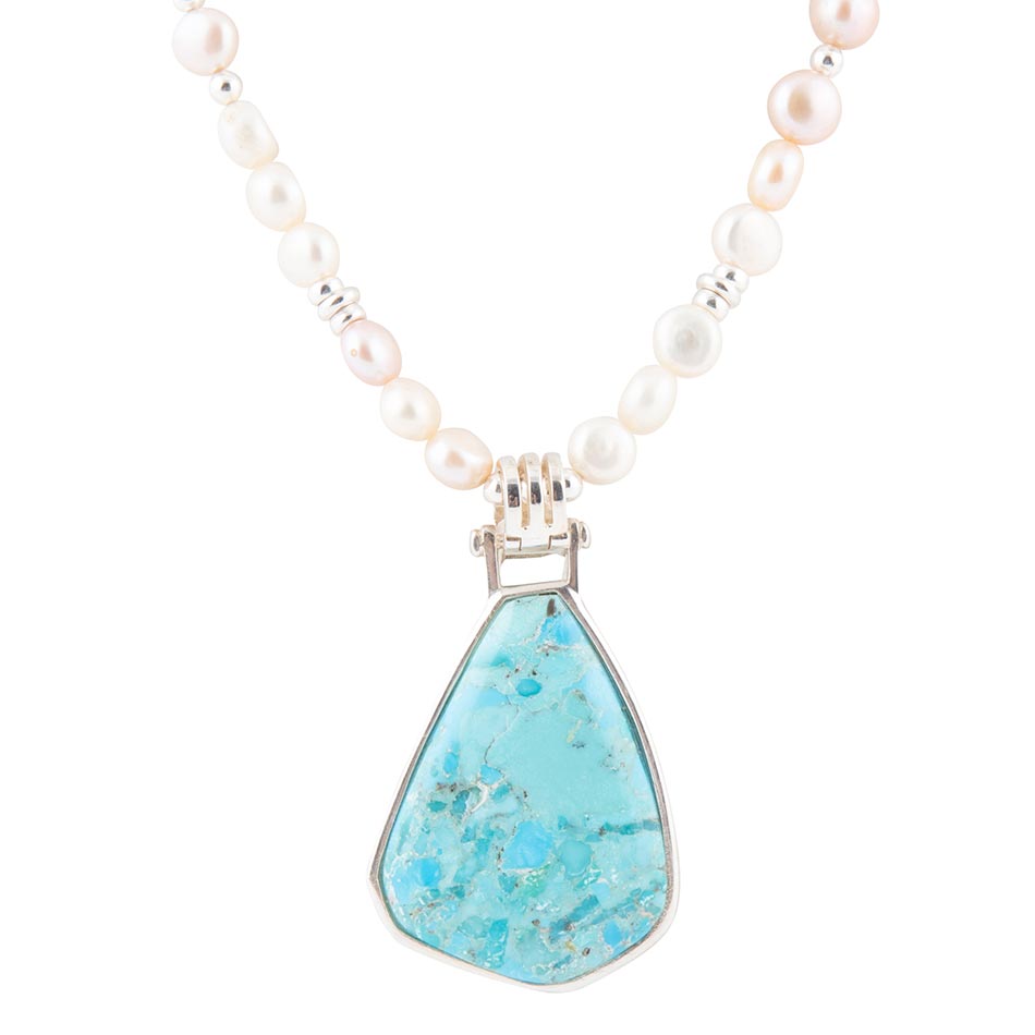 Necklace with pearls and a turquoise pendant on a white background