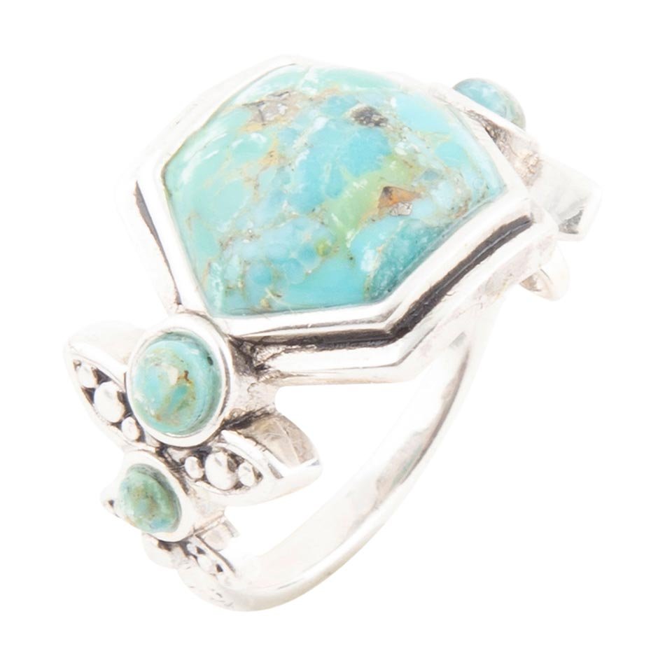 Turquoise stone ring with silver band on a white background