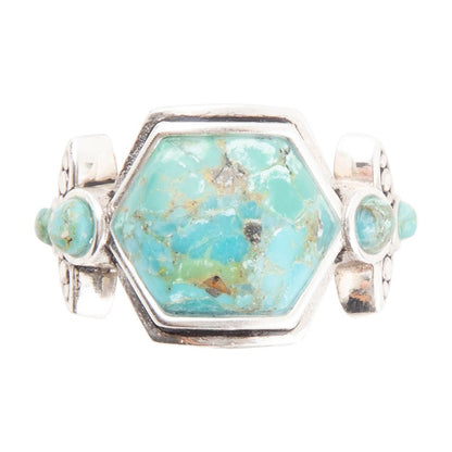 Turquoise stone ring with silver band on a white background