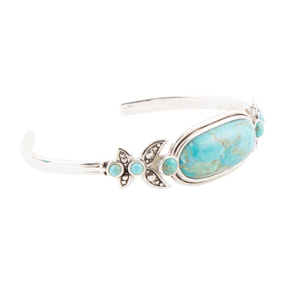 Turquoise stone bracelet with silver accents on a white background