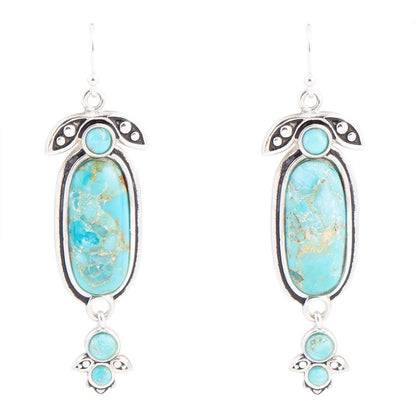 Turquoise stone earrings with silver accents on a white background