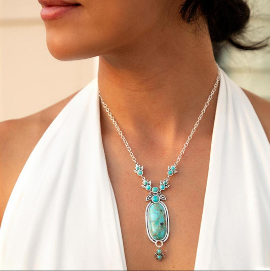 Woman wearing a turquoise necklace with a blurred background