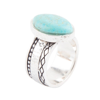 Silver ring with a turquoise stone on a white background