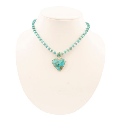 Turquoise necklace with a heart-shaped pendant on a white background