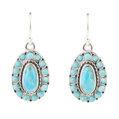 Turquoise stone earrings with silver frames on a white background