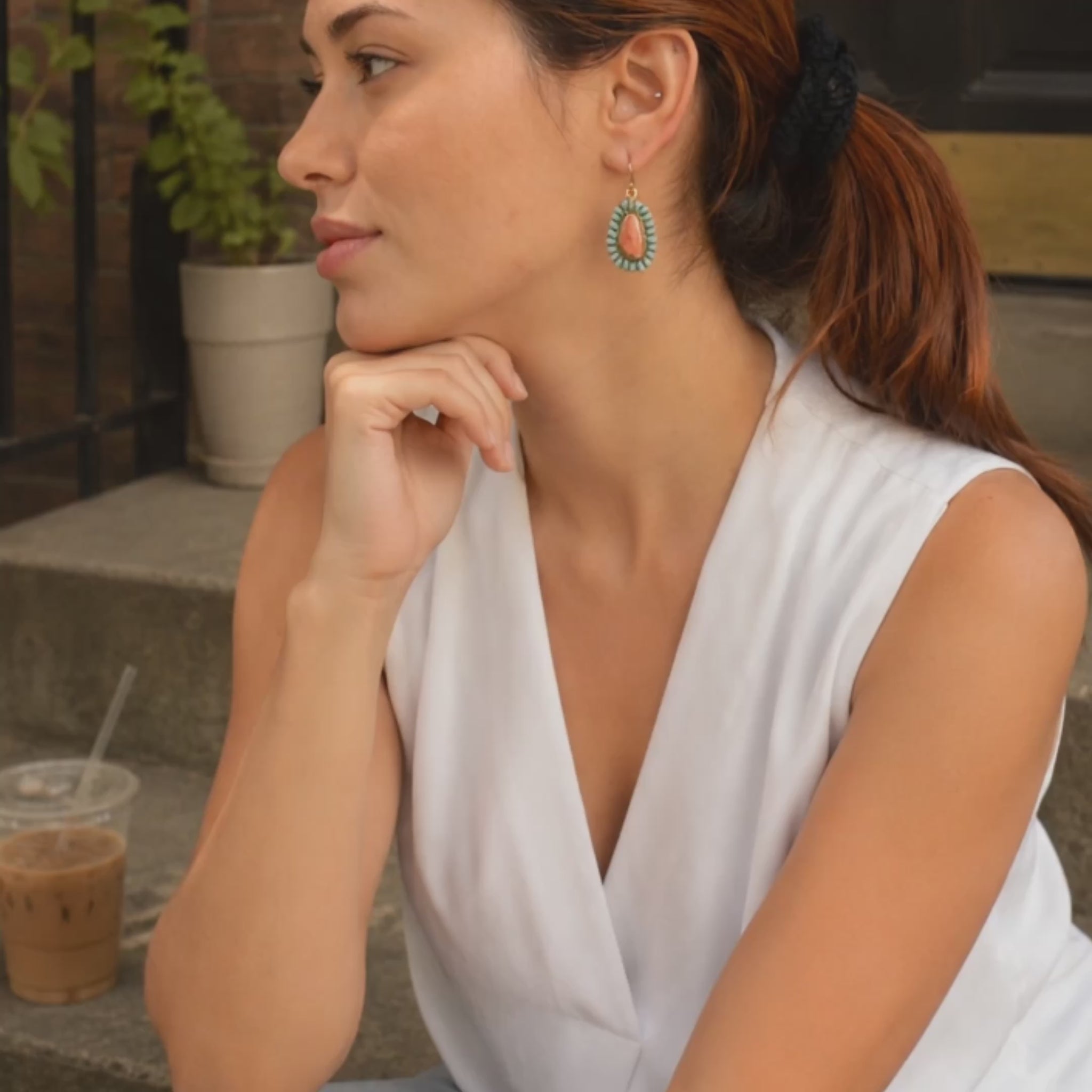 Model showing Sedona natural turquoise and orange sponge coral gold-tone bronze drop earrings