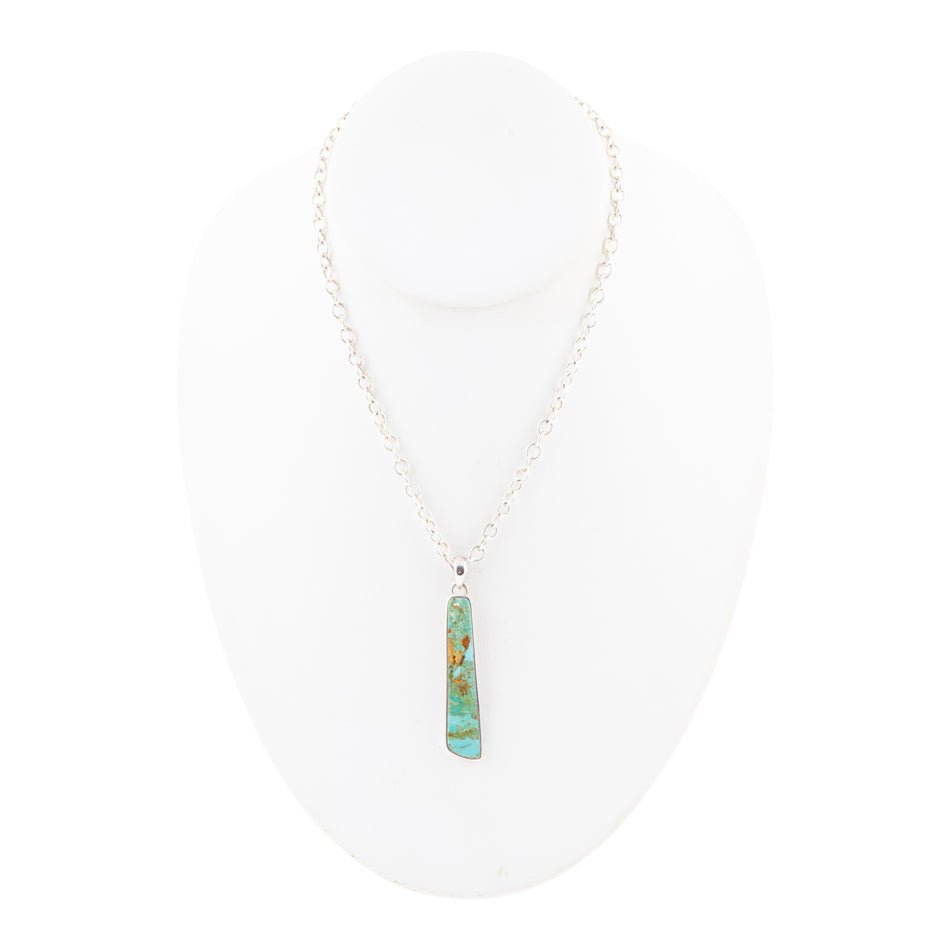 Turquoise pendant necklace on a white background