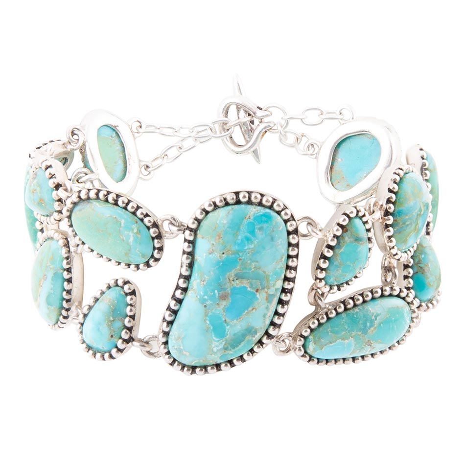Turquoise stone bracelet with silver accents on a white background