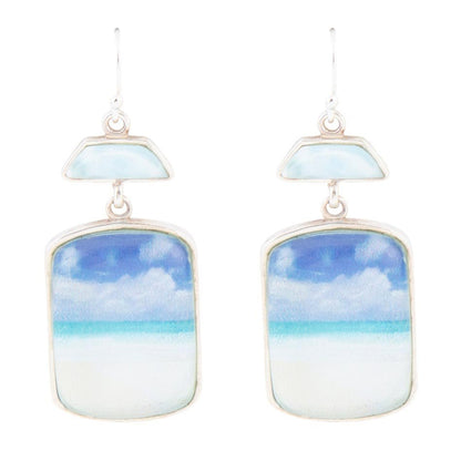 Earrings with sky and cloud design on a white background