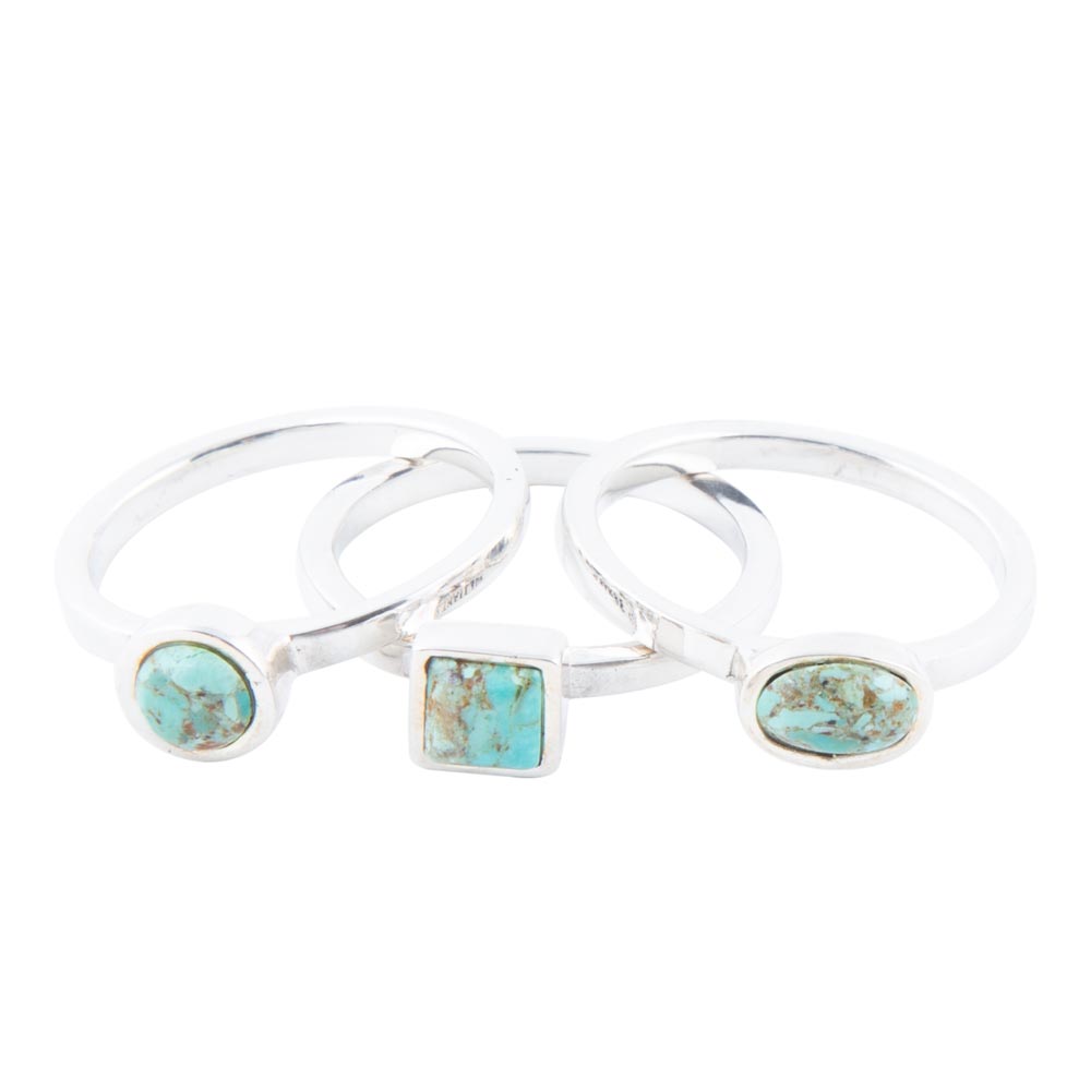 Three silver rings with turquoise stone inlays on a white background