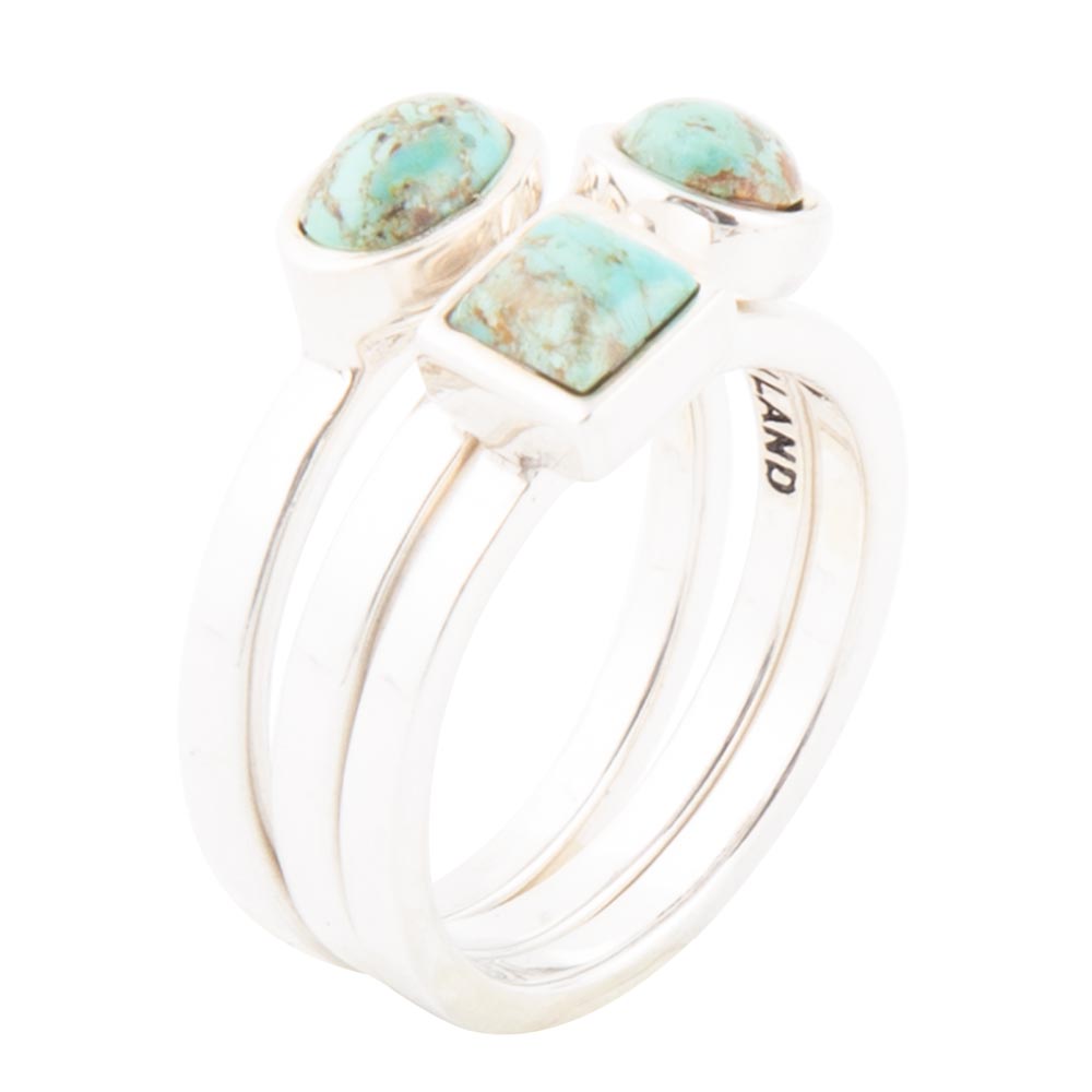 Silver ring with turquoise stones on a white background