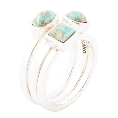 Silver ring with turquoise stones on a white background